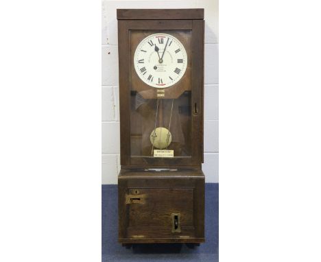 A George V Gledhill-Brook Time Recorders Ltd oak cased clocking-in clock, the signed painted circular dial with black Roman h