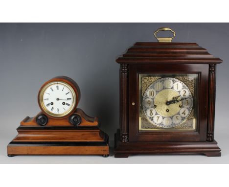 A late 19th century French walnut and ebonized mantel clock with eight day movement striking on a bell via an outside countwh