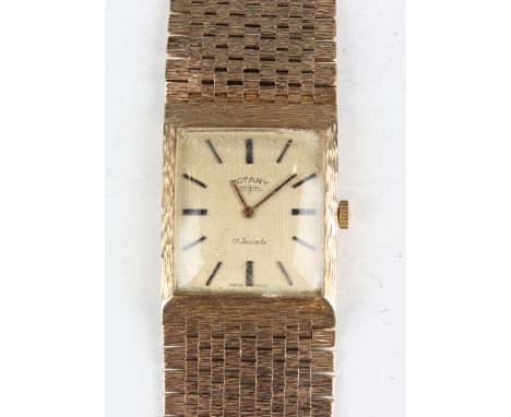 A Rotary 9ct gold gentleman's bracelet wristwatch, the signed gilt square dial with black baton hour markers, the tapered bri