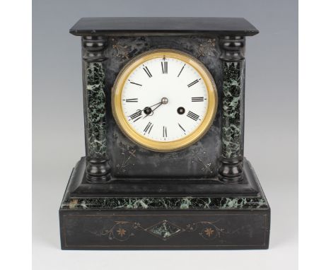 A late 19th century slate mantel clock with eight day movement striking on a bell, the enamelled dial with black Roman hour n