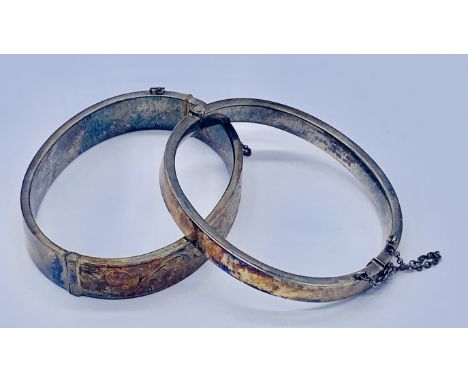 Two silver hinged bracelets both with gold fronts
