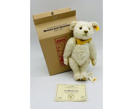 A boxed Steiff by Danbury Mint "Millennium" mohair teddy bear with yellow ribbon, pendent, original label and certificate of 
