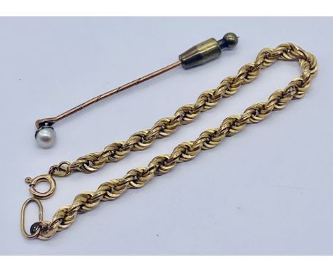 A 9ct gold rope bracelet, weight 3.9g along with a yellow metal stick pin