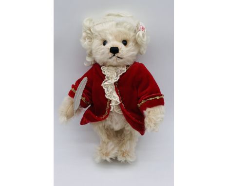 An unboxed Steiff "Mozart" teddy bear with musical clockwork mechanism and quill, dressed in red costume and curled wig  (No 