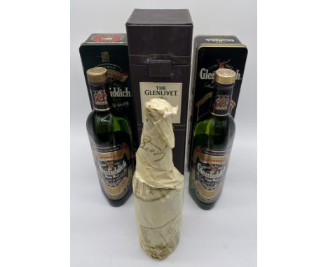 A bottle of "The Glenlivet" 15 year old French oak reserve single malt Scotch whisky along with two bottles of Glenfiddich pu