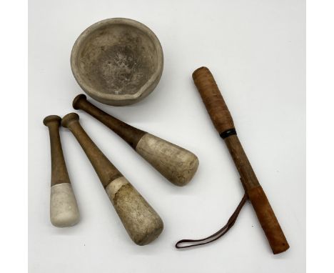 An antique mortar and three graduated pestles along with a leather covered truncheon or club