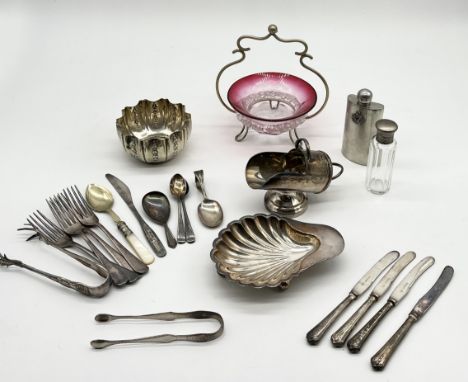 A small collection of silver plated items along with a set of Georgian silver sugar tongs and silver handled butter knives