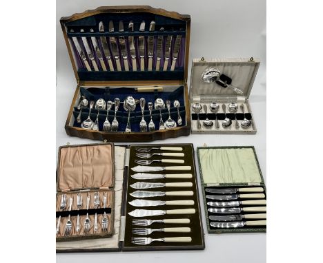 A collection of cased silver plated cutlery including wooden canteen