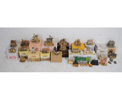 A collection of ceramic model cottages and buildings, including David Winter Cottages, Fraser Creations, Penthouse & Pavement