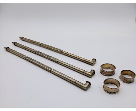 Three SCM opium pipes and three assorted silver hallmarked napkin rings.