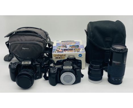 Two Minolta Dynax 300si camera's (one boxed, one in soft carry case), along with two Minolta lens in soft carry case