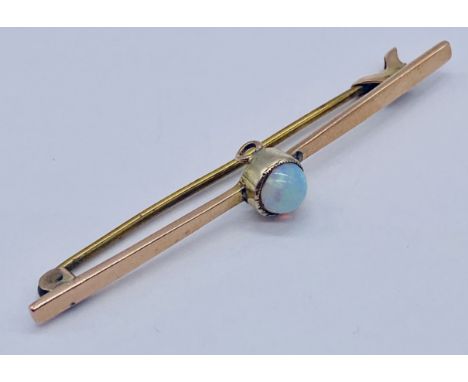 A 9ct gold bar brooch set with an opal, total weight 2.1g