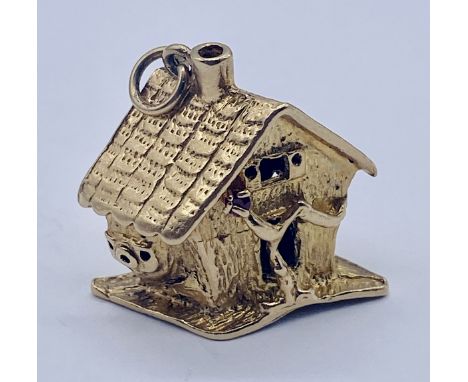 A 9ct gold charm in the form of a treehouse, set with a ruby, weight 11.6g