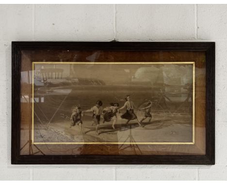 A framed black and white print of children playing on a beach. Marked to corner W. Field 1873. 110cm x 66cm