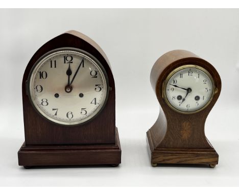 An Edwardian inlaid balloon mantel clock along with another oak cased example