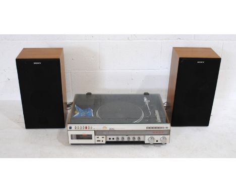 A vintage Sony HMK-3000 stereo music system, with a pair of Sony SS-E20 8 ohm bookshelf speakers - the front of one speaker h