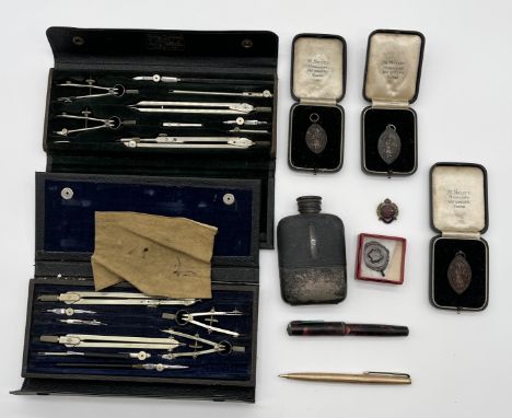 Two drawing sets, hip flask, two fountain pens, medallions etc.