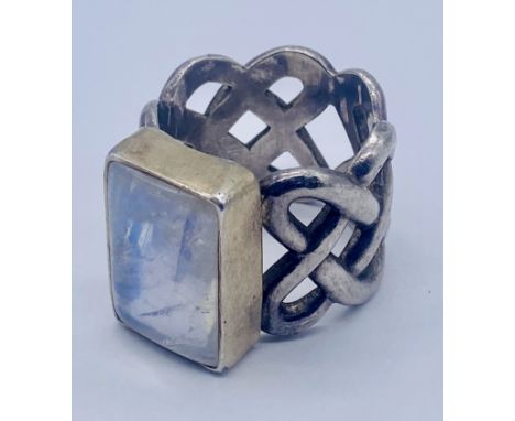 A large unmarked silver ring set with a moonstone, size Z