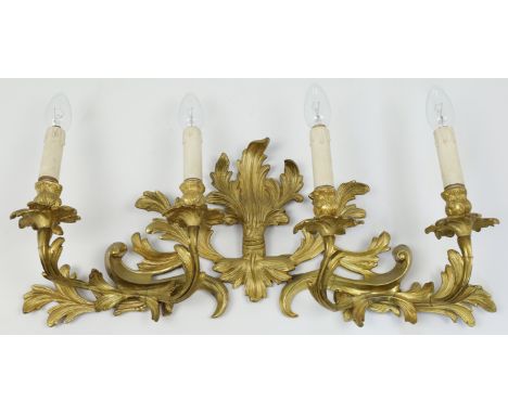 A French rococo ormolu four branch wall light, 19th century, the stems issuing from a scrolling leaf backplate, approximately