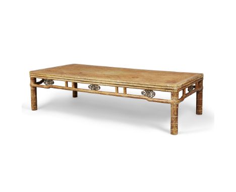 A Chinese softwood opium bedLate Qing dynastythe rectangular rattan-inset top above open frieze set with carved and pierced p