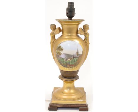 A gilded porcelain and gilt metal French Empire style table lamp, 20th century, modelled as a baluster vase with twin handles