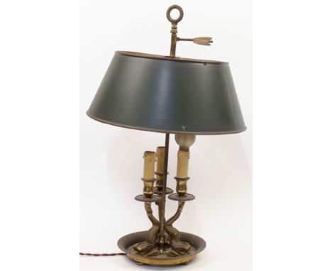 A brass bouillotte lamp, early 20th century, designed with three dolphins supporting three faux candle sconces, the adjustabl