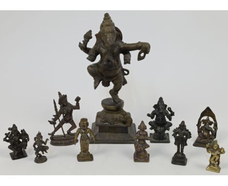 A bronze figure of a dancing Ganesha atop a leaf moulded base, 20th century, 17cm high, together with a collection of miniatu