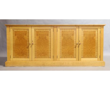 In the Manner of David Linley, a bespoke light oak and burl wood low cabinet, 21st century, the moulded stepped cornice above