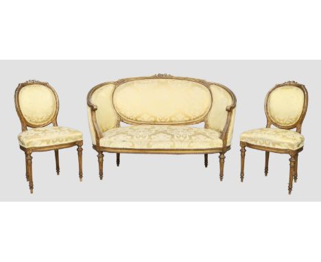 A French giltwood sofa and a pair of matching side chairs, Louis XVI style, first quarter 20th century, carved frames and sil