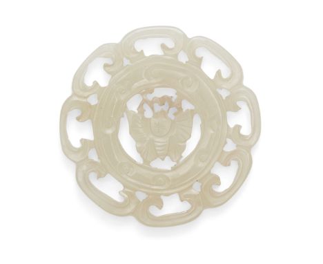 A Chinese 'butterfly' jade plaque, late 19th/early 20th century, the circular plaque pierced and carved with a butterfly in t