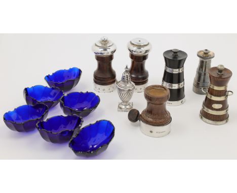 A group of pepper mills, including: an ebony and silver mounted lighthouse pepper mill, Birmingham, 1925, Hukin & Heath, 9.8c