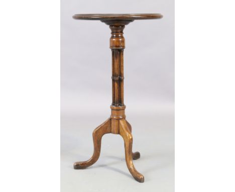 A George III style mahogany tripod table, 20th century, the circular top with four ring turned column supports, raised on thr