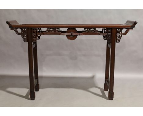 A Chinese hardwood altar table, 20th century, carved and pierced frieze, raised on block supports to carved feet, 86cm high, 