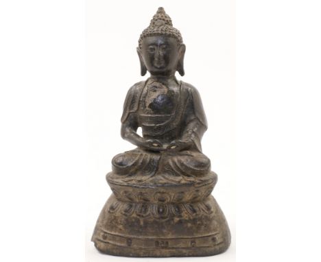 A Chinese bronze figure of a seated buddha, 19th century, with serene smiling face, closed eyelids and elongated earlobes, in