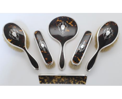 An Edwardian six-piece silver mounted tortoiseshell dressing table set, Birmingham, 1923, Adie Brothers Ltd, comprising a han