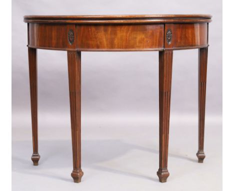 A George III mahogany demi lune tea table, last quarter 18th century, on reeded legs to spade feet, 73cm high, 91cm wide, 45c