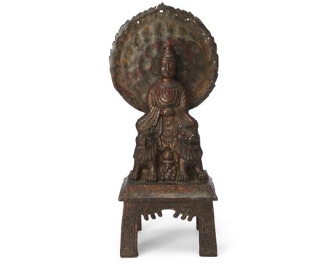 A Tibetan lacquered bronze figure of Shakyamuni Buddha, early 20th century, cast seated on two lions raised on square base, w