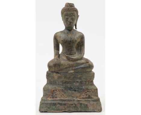 A Burmese bronze buddha, 18th century, depicted seated with serene smiling face, closed eyelids and elongated earlobes (one m