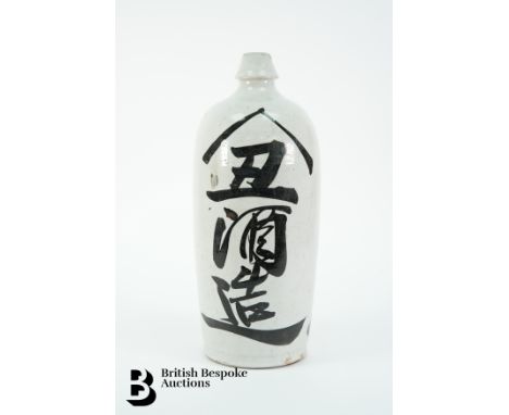 An early 20th century Japanese pottery flask, approx 39&nbsp; cms, decorated with Japanese calligraphy.&nbsp;