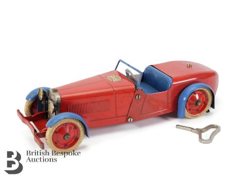 A vintage Meccano Constructor car, made as an open two seater tourer, red finish with blue seats and wheel guards, red wheels