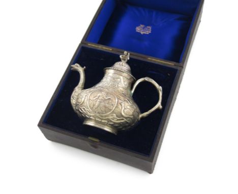 A 19th century Dutch silver tea pot, in the 18th century Frisian manner, pear form, embossed with figures, birds and foliate 