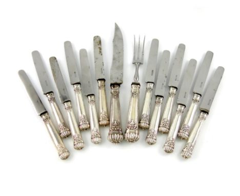 A set of twelve continental silver table knives and a carving knife and fork, fluted terminals, with stylised foliate decorat