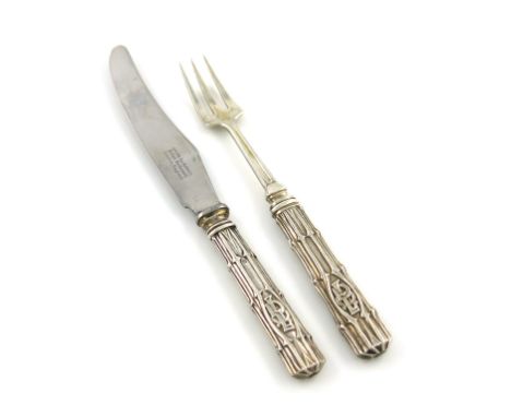 By Omar Ramsden, an Arts and Crafts silver knife and fork, London 1932, textured tapering handles applied with initials, the 