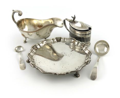 A mixed lot of silver items, comprising: an Edwardian waiter, London 1903, moulded border, the centre with a crest, plus a mu