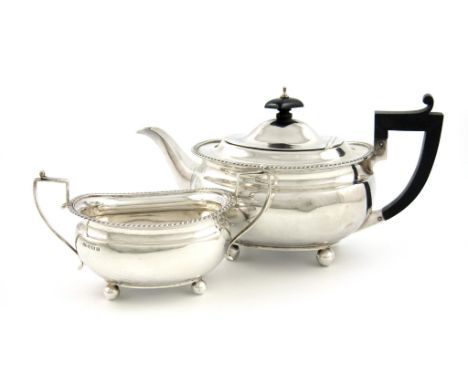 A silver teapot and sugar bowl, by Docker & Burn Ltd, Birmingham 1924 and 1928, oblong bellied form, gadroon borders, scroll 