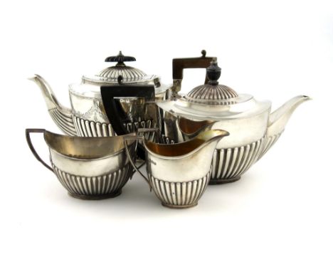 A three-piece silver bachelor's tea set, by The Goldsmiths and Silversmiths Company, Sheffield 1914, oval form, part-fluted d