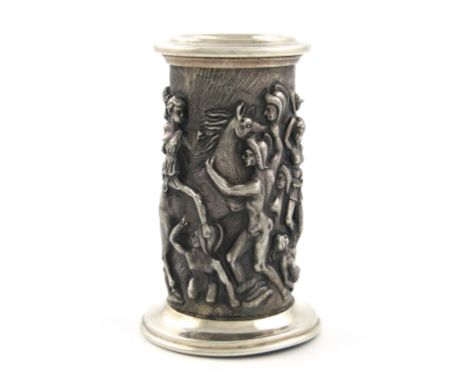 A modern Spanish silver candlestick, cylindrical form, embossed with classical warriors and horses, on a spread circular foot