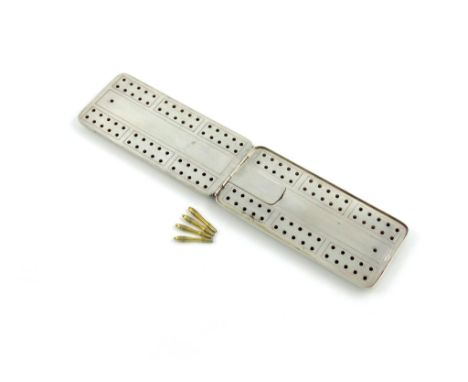 An American silver travelling cribbage board, by Theodore B. Starr, New York, rectangular form, foliate borders, the hinged c