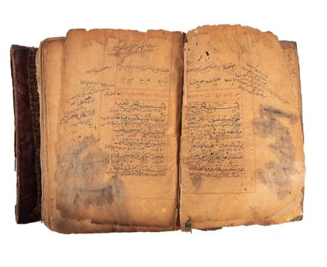 QURAN, Arabic manuscript on paper, possibly from Yemen, possibly 19th century, red ruled throughout, page losses, damp staine
