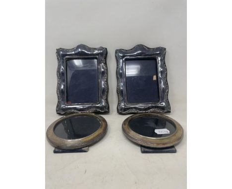 A pair of silver mounted photograph frames, 21 x 16 cm, and a pair of round photograph frames, 14 cm diameter (4)
